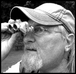 Man looking through vintage micro binoculars