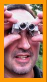 amused man using Miniature Binoculars